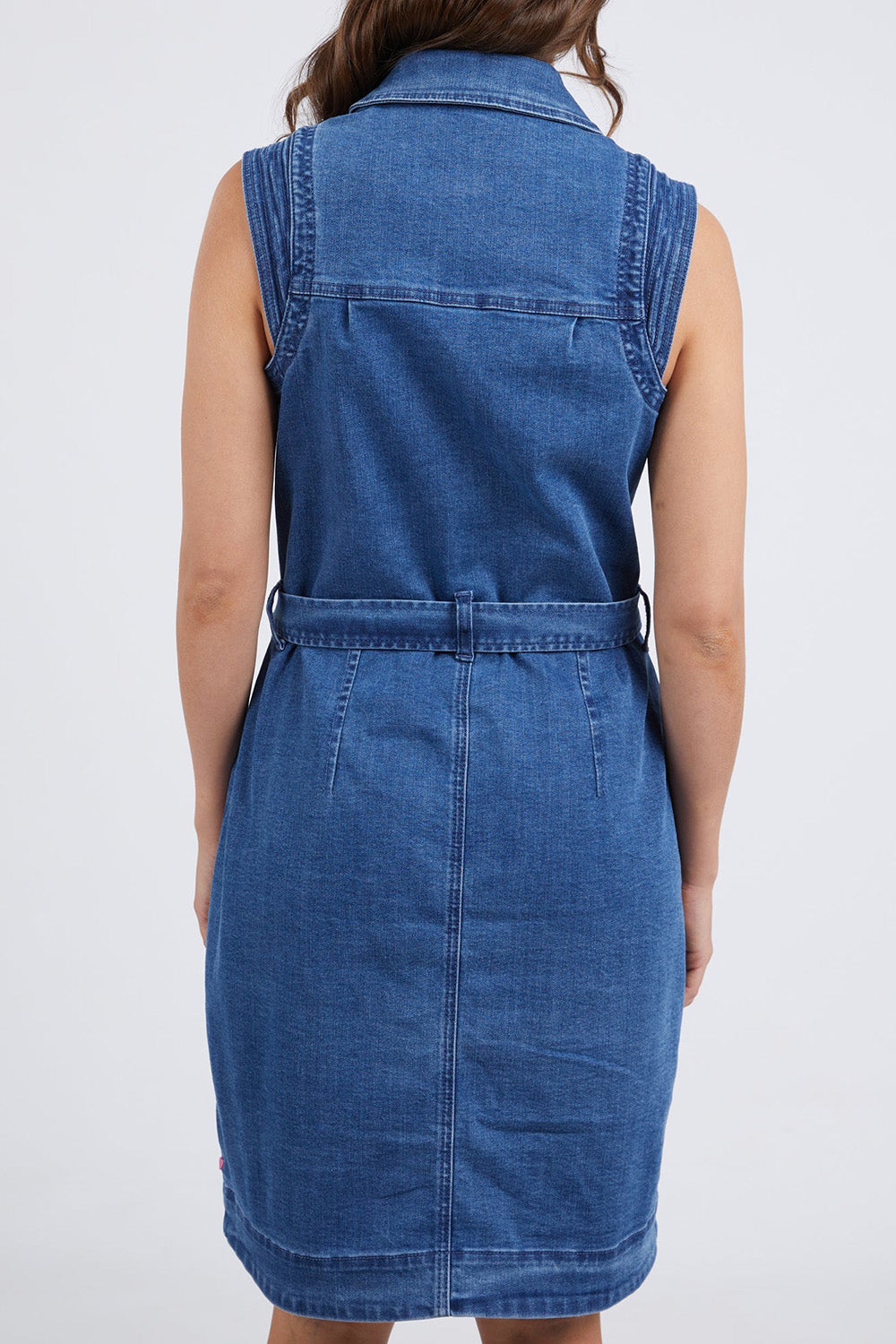 A model wearing the Daisy Denim Dress in colour Bluewash (Blue), from the back