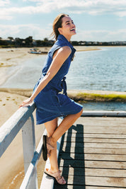 A model wearing the Daisy Denim Dress in colour Bluewash (Blue), from the front, showing the whole outfit