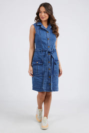 A model wearing the Daisy Denim Dress in colour Bluewash (Blue), from the front, showing the whole outfit