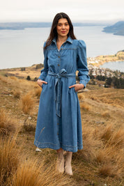 A model wearing the Lucinda Denim Shirt Dress in colour Denim (Blue), from the front, showing the whole outfit