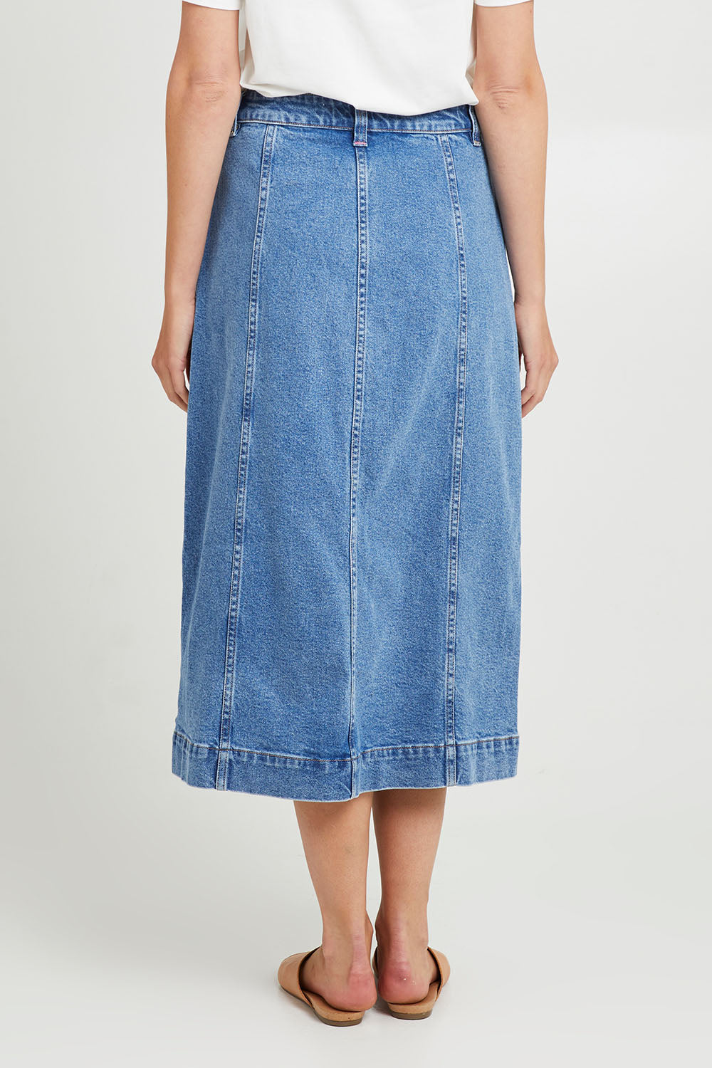 Model Madeline wearing size 10 of the Florence Button Through Skirt in colour Midblue (Blue), from the back