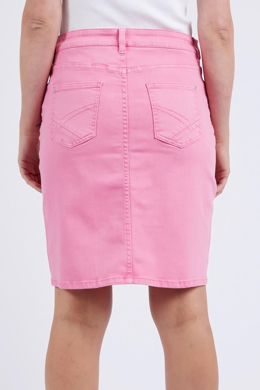 A model wearing the Belle Denim Skirt in colour Strawberry (Pink), from the back