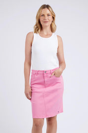 A model wearing the Belle Denim Skirt in colour Strawberry (Pink), from the front, cropped image