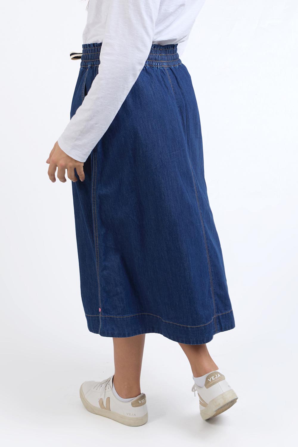 A model wearing the Fundamental Greta Denim Skirt in colour Darkblue (Blue), from the back