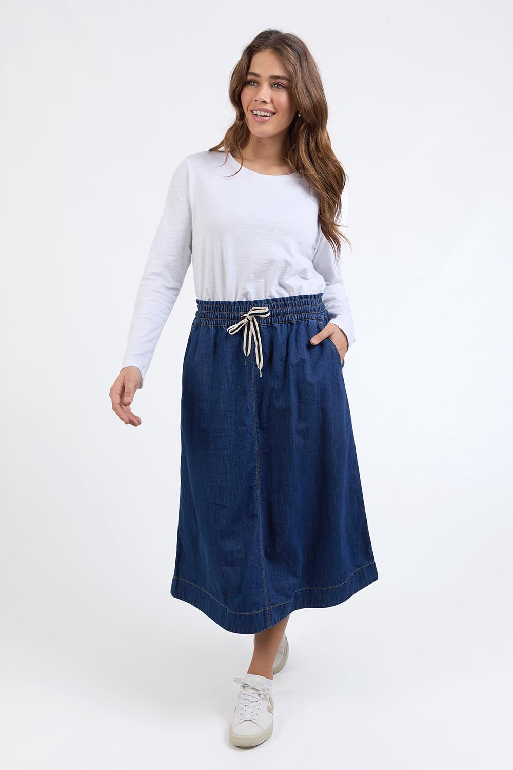 A model wearing the Fundamental Greta Denim Skirt in colour Darkblue (Blue), from the front, showing the whole outfit