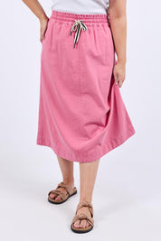 A model wearing the Greta Denim Skirt in colour Chateauros (Pink), from the front, cropped image