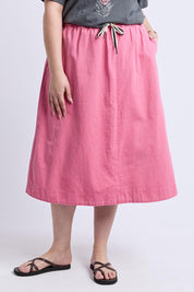 A model wearing the Greta Denim Skirt in colour Chateauros (Pink), from the front, cropped image