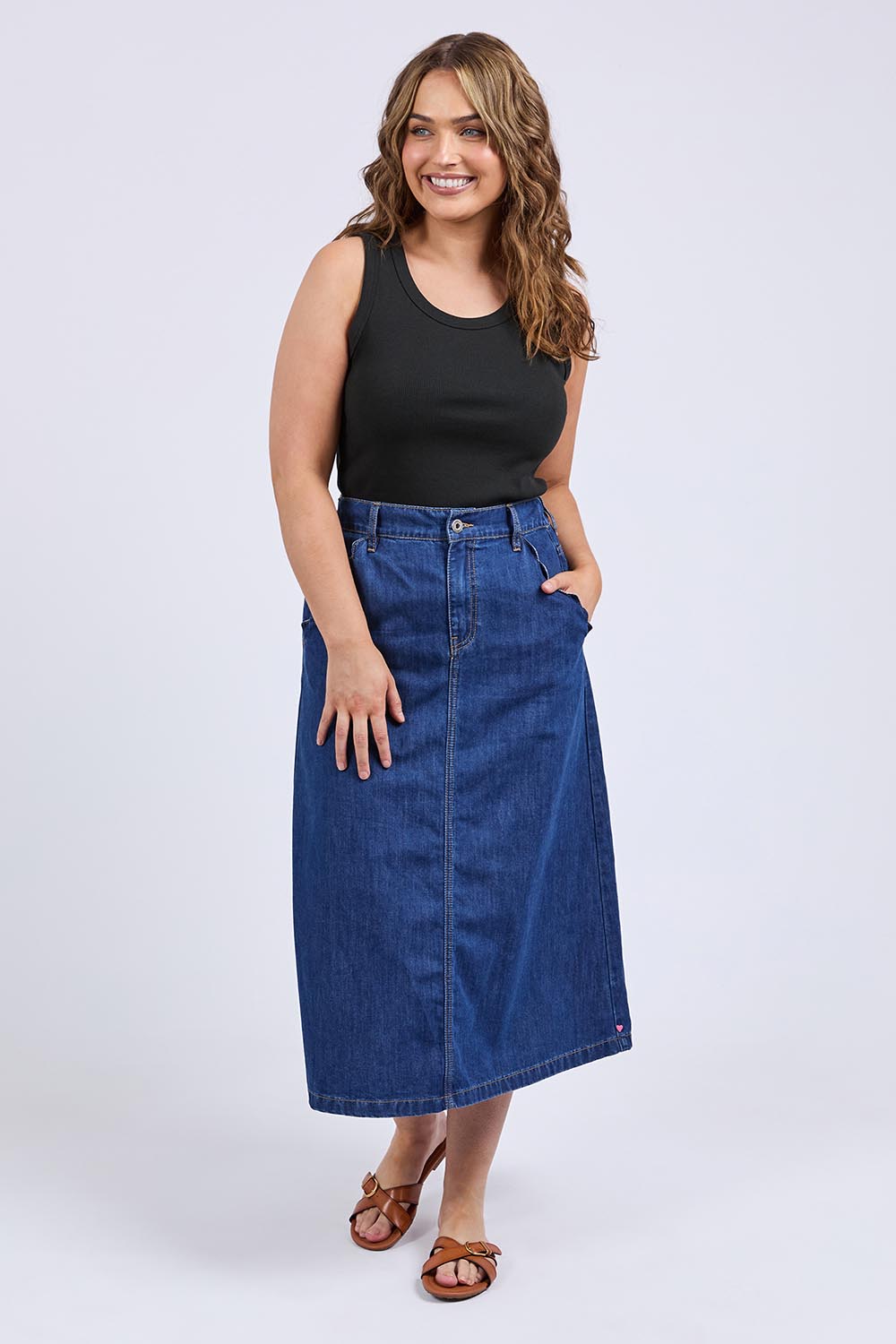A model wearing the Scallop Edge Denim Skirt in colour Midblue (Blue), from the front, showing the whole outfit