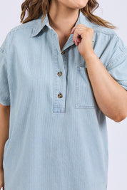 A model wearing the Jenna Stripe Denim Dress in colour Bluewhite (Blue), from the front, cropped image