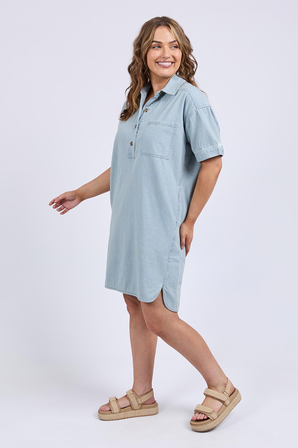 A model wearing the Jenna Stripe Denim Dress in colour Bluewhite (Blue), from the front, showing the whole outfit