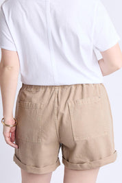 A model wearing the Emma Relaxed Cotton Short in colour Latte, from the back