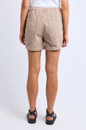 A model wearing the Emma Relaxed Cotton Short in colour Latte, from the back