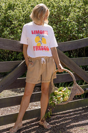 A model wearing the Emma Relaxed Cotton Short in colour Latte, from the front, showing the whole outfit