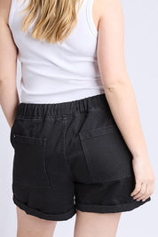 Model Genericm wearing size sample of the Fundamental Emma Relaxed Denim Short – Black in colour Black, from the back