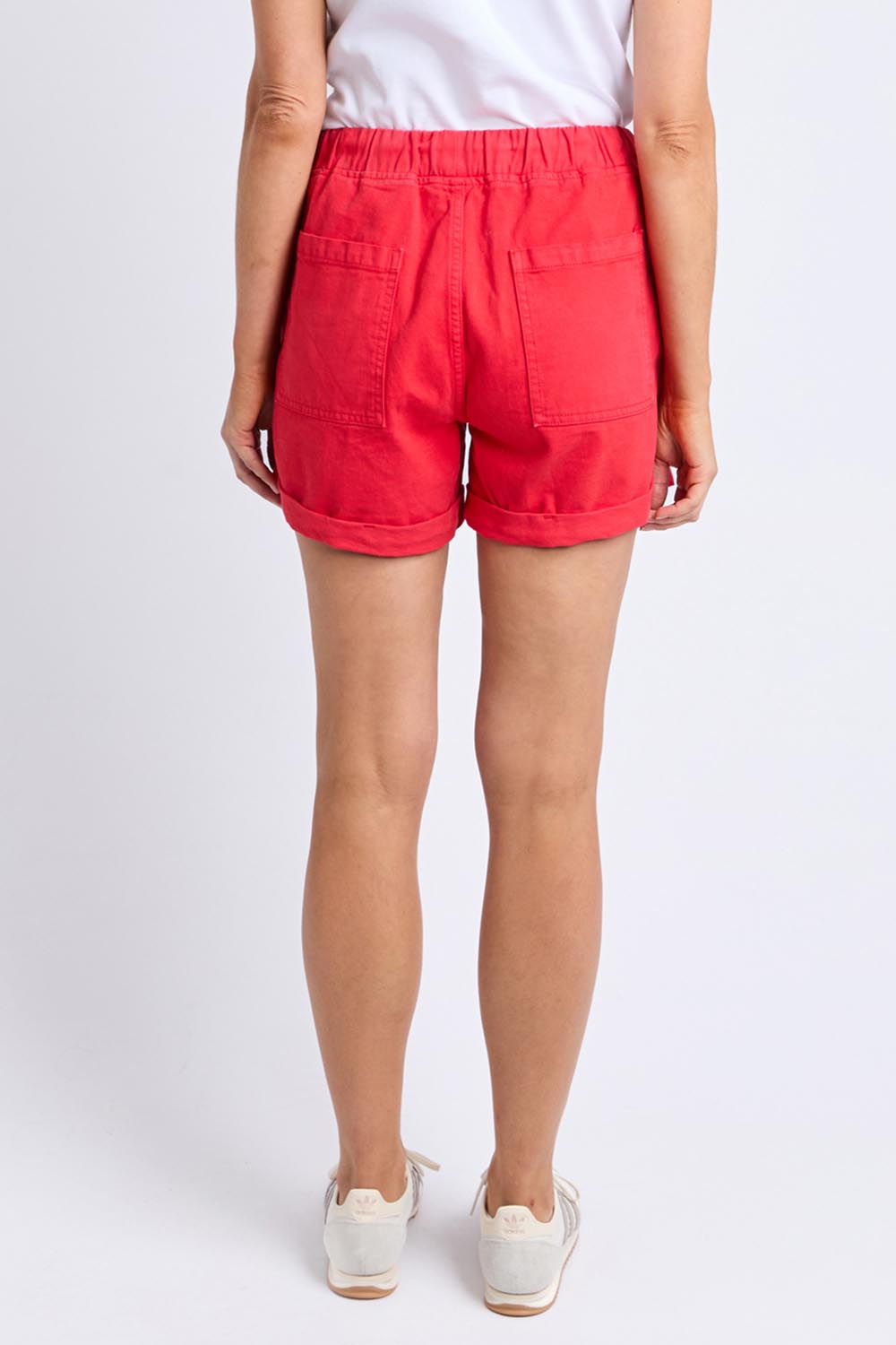 A model wearing the Emma Relaxed DenimShort in colour Poppy (Red), from the back