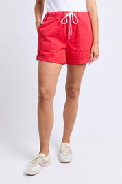 A model wearing the Emma Relaxed DenimShort in colour Poppy (Red), from the front, cropped image