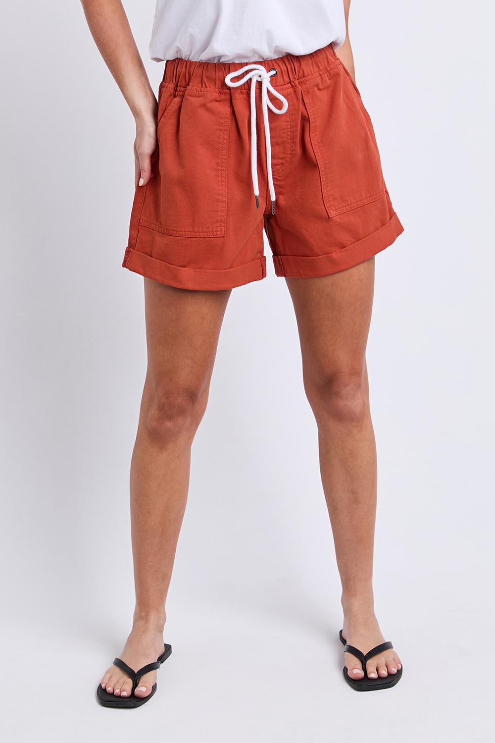 Model Genericm wearing size sample of the Fundamental Emma Relaxed Denim Short – Earthbrown in colour Earthbrown, in a cropped view