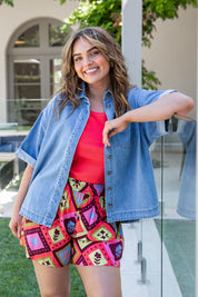 A model wearing the Annika Ss Denim Shirt in colour Midblue (Blue), from the front, showing the whole outfit