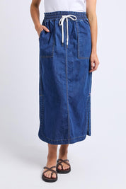 A model wearing the Clover Midi Denim Skirt in colour Midblue (Blue), from the front, cropped image