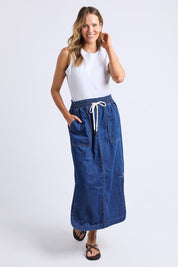 A model wearing the Clover Midi Denim Skirt in colour Midblue (Blue), from the front, showing the whole outfit