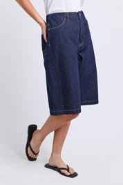 Model Genericm wearing size sample of the Faith Denim Shorts – Dblue in colour Dblue, from an angle