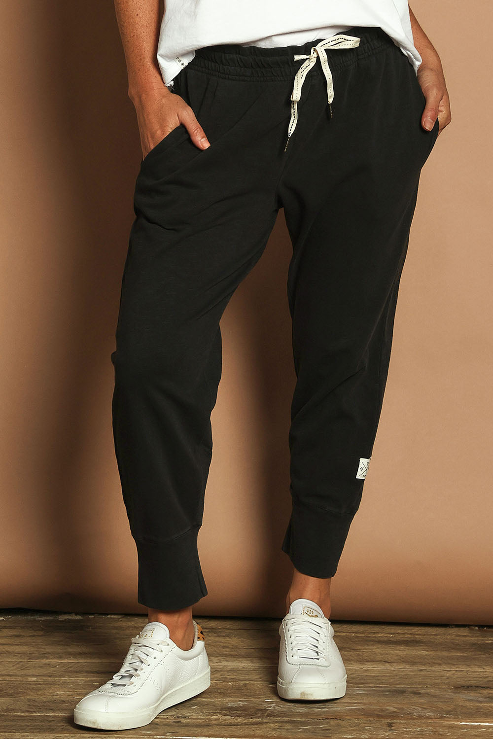 Model Katie wearing size 10 of the Fundamental Brunch Cotton Pant in colour Black (Black), from the front, cropped image