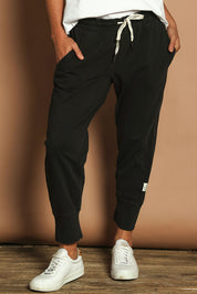 Model Katie wearing size 10 of the Fundamental Brunch Cotton Pant in colour Black (Black), from the front, cropped image