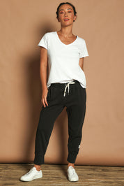 Model Katie wearing size 10 of the Fundamental Brunch Cotton Pant in colour Black (Black), from the front, showing the whole outfit