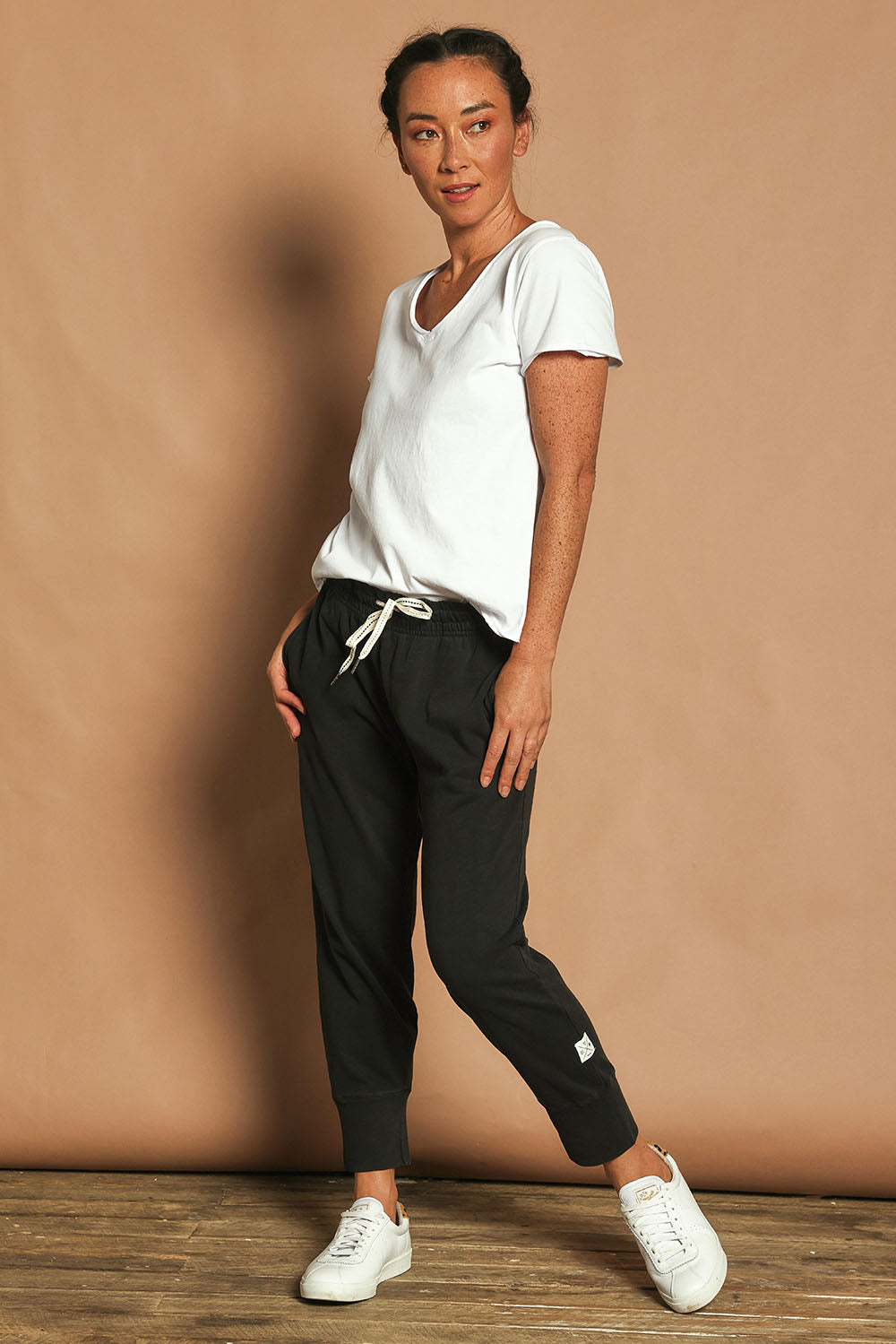 Model Katie wearing size 10 of the Fundamental Brunch Cotton Pant in colour Black (Black), from the front, showing the whole outfit