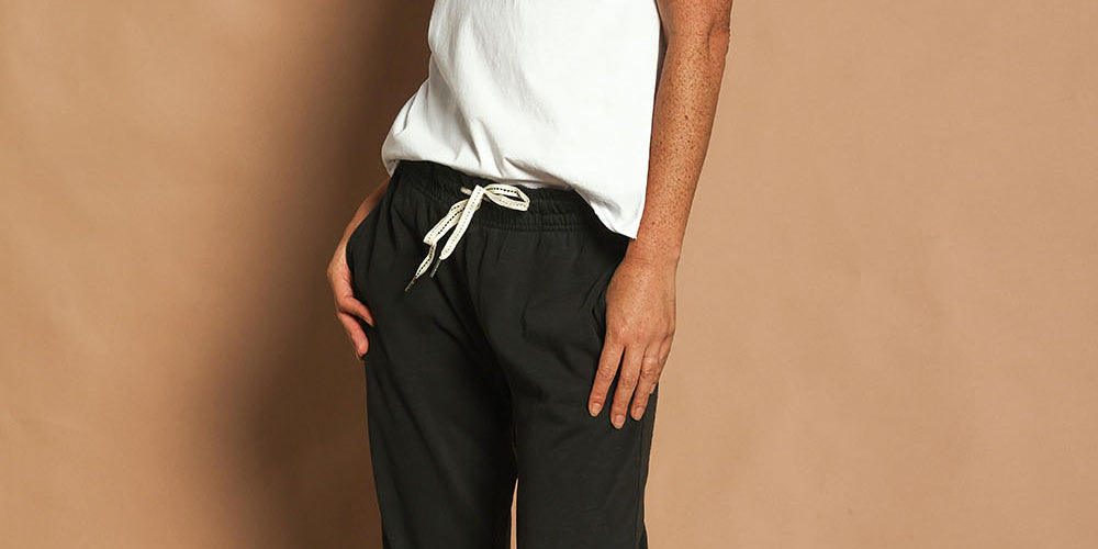 Model Katie wearing size 10 of the Fundamental Brunch Cotton Pant in colour Black (Black), from the front, showing the whole outfit