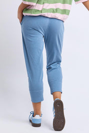 A model wearing the Fundamental Brunch Cotton Pant in colour Blueshadow (Blue), from the back