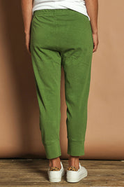 Model Katie wearing size 10 of the Fundamental Brunch Cotton Pant in colour Cedargreen (Green), from the back