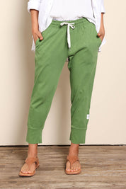 Model Pamelar wearing size 10 of the Fundamental Brunch Cotton Pant - Cedargreen in colour Cedargreen, in a cropped view