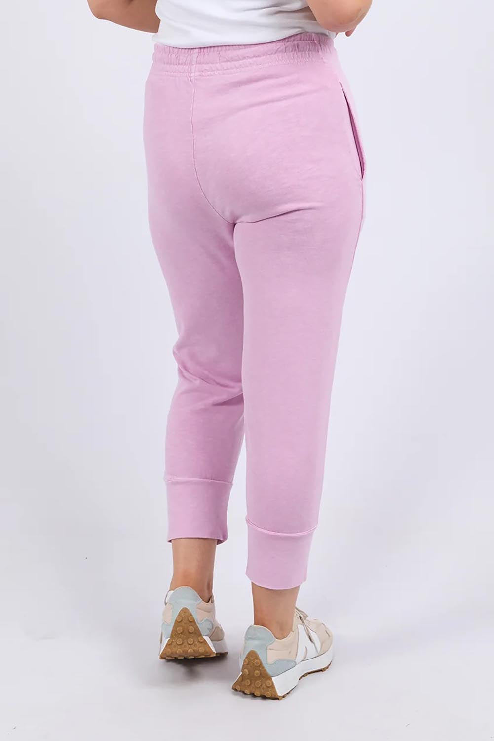 A model wearing the Fundamental Brunch Cotton Pant in colour Duskpink (Pink), from the back
