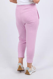 A model wearing the Fundamental Brunch Cotton Pant in colour Duskpink (Pink), from the back