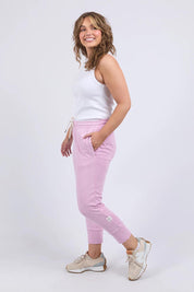 A model wearing the Fundamental Brunch Cotton Pant in colour Duskpink (Pink), from the front, showing the whole outfit