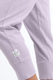 A model wearing the Fundamental Brunch Cotton Pant in colour Dustylilac (Purple), from the front, showing the whole outfit