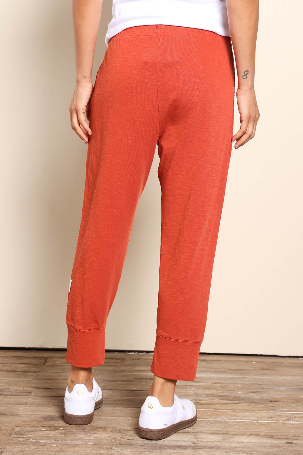 Model Pamelar wearing size 10 of the Fundamental Brunch Cotton Pant – Earthbrown in colour Earthbrown, from the back