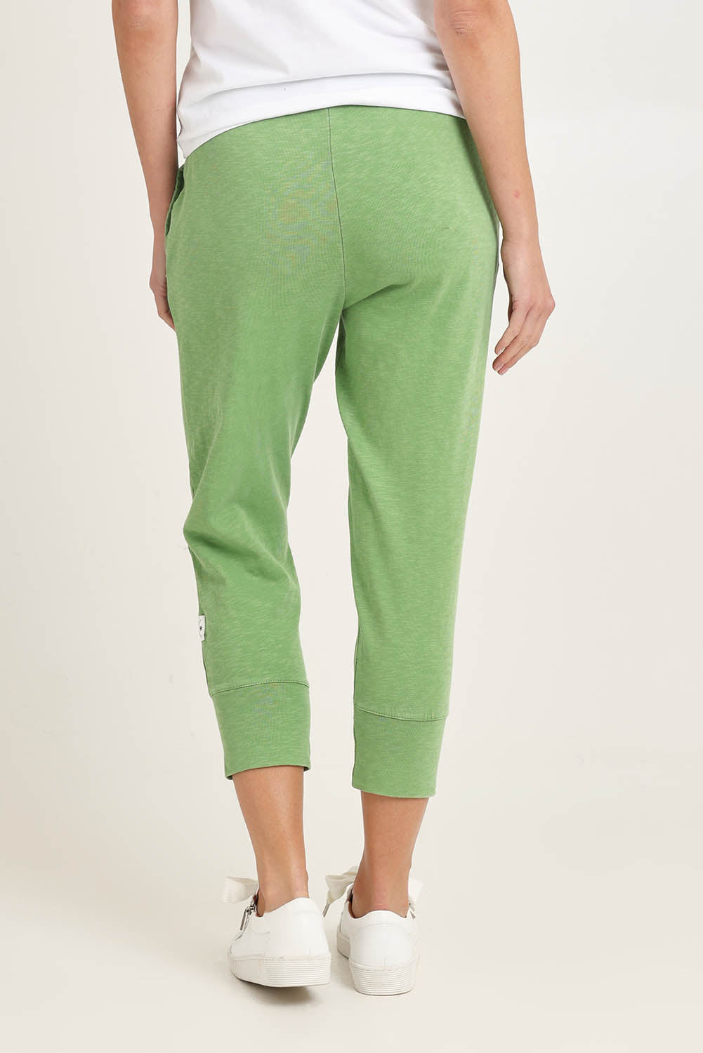 Model Madeline wearing size 10 of the Fundamental Brunch Cotton Pant in colour Forest (Green), from the back