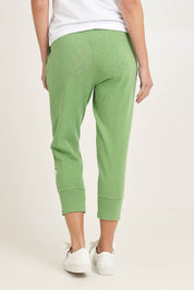 Model Madeline wearing size 10 of the Fundamental Brunch Cotton Pant in colour Forest (Green), from the back