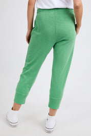 A model wearing the Fundamental Brunch Cotton Pant in colour Greenbriar (Green), from the back