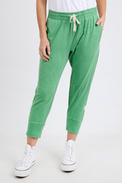 A model wearing the Fundamental Brunch Cotton Pant in colour Greenbriar (Green), from the front, cropped image