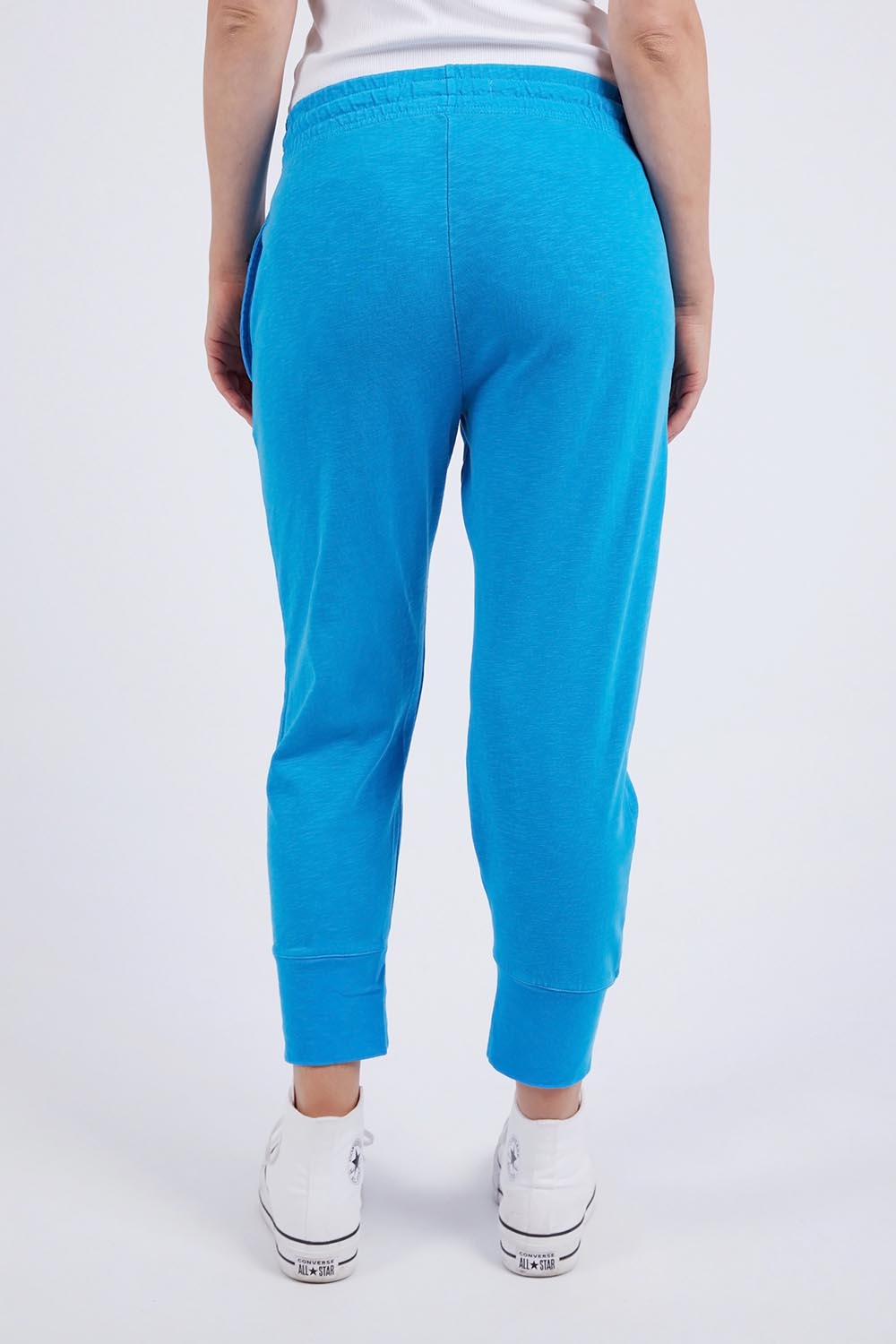 A model wearing the Fundamental Brunch Cotton Pant in colour Ibizablue (Blue), from the back