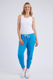 A model wearing the Fundamental Brunch Cotton Pant in colour Ibizablue (Blue), from the front, showing the whole outfit