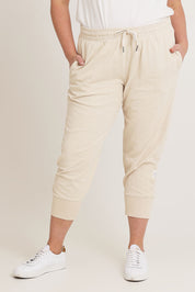 Model Chanel wearing size 16 of the Fundamental Brunch Cotton Pant in colour Linen, from the front, cropped image