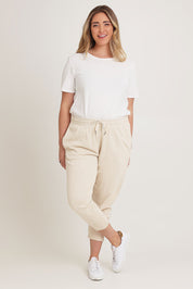 Model Chanel wearing size 16 of the Fundamental Brunch Cotton Pant in colour Linen, from the front, showing the whole outfit