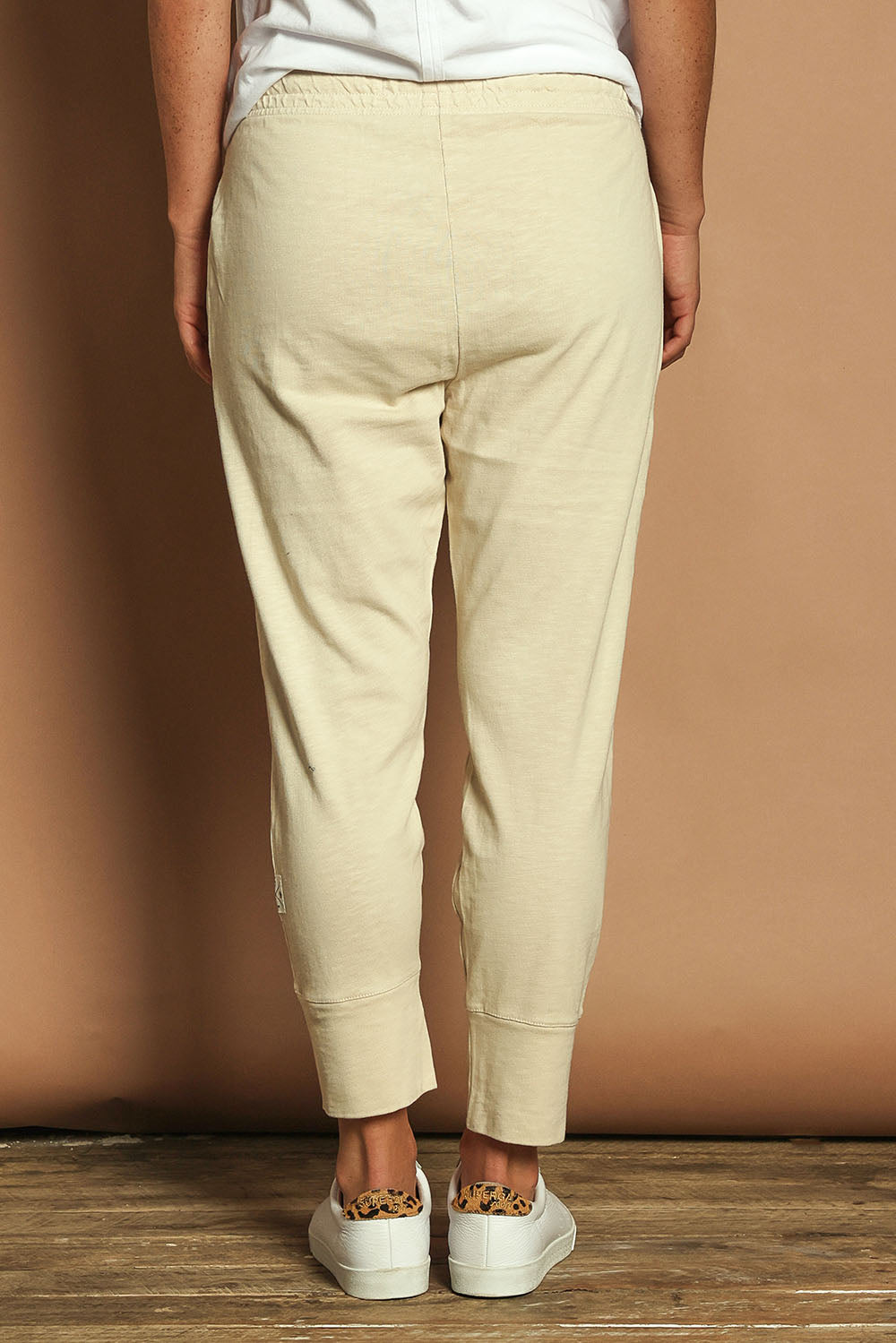 Model Katie wearing size 10 of the Fundamental Brunch Cotton Pant in colour Linen, from the back