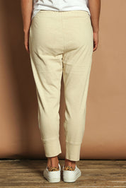 Model Katie wearing size 10 of the Fundamental Brunch Cotton Pant in colour Linen, from the back