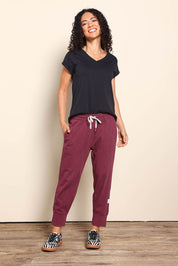 Model Pamelar wearing size 10 of the Fundamental Brunch Cotton Pant - Merlot in colour Merlot, from the front