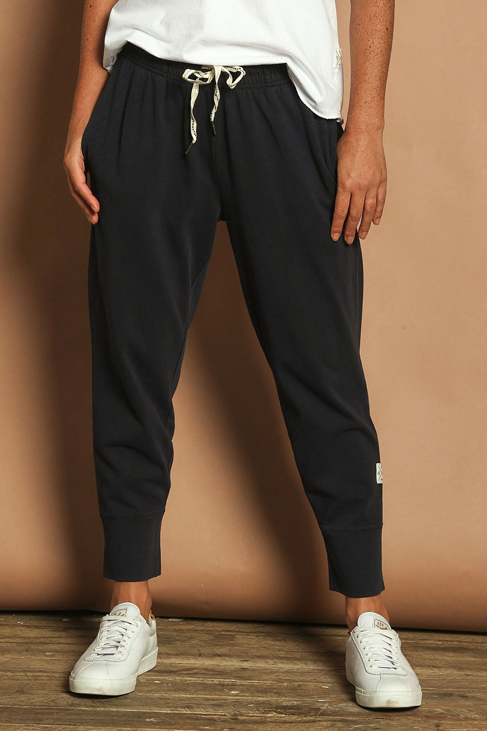 Model Katie wearing size 10 of the Fundamental Brunch Cotton Pant in colour Navy (Blue), from the front, cropped image
